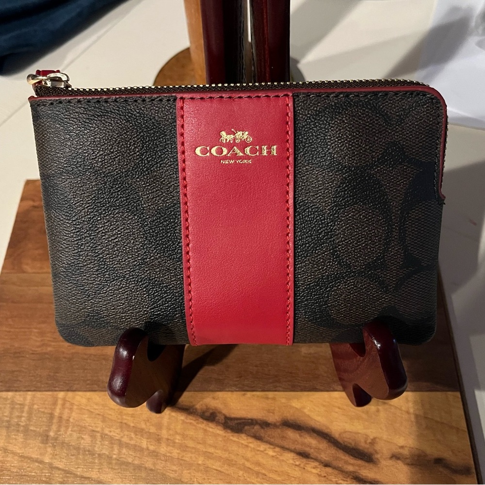 NEW. Coach coin/I.D. With zipper.   With leather strap and Coach label.